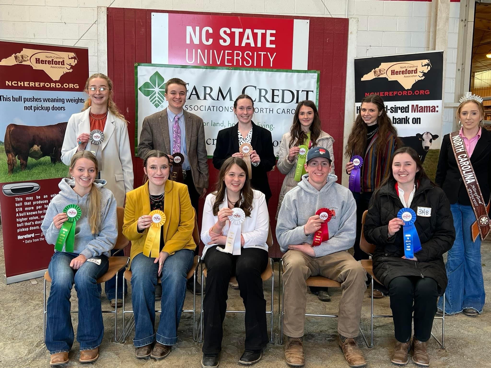 A group of award winners holding their ribbons.